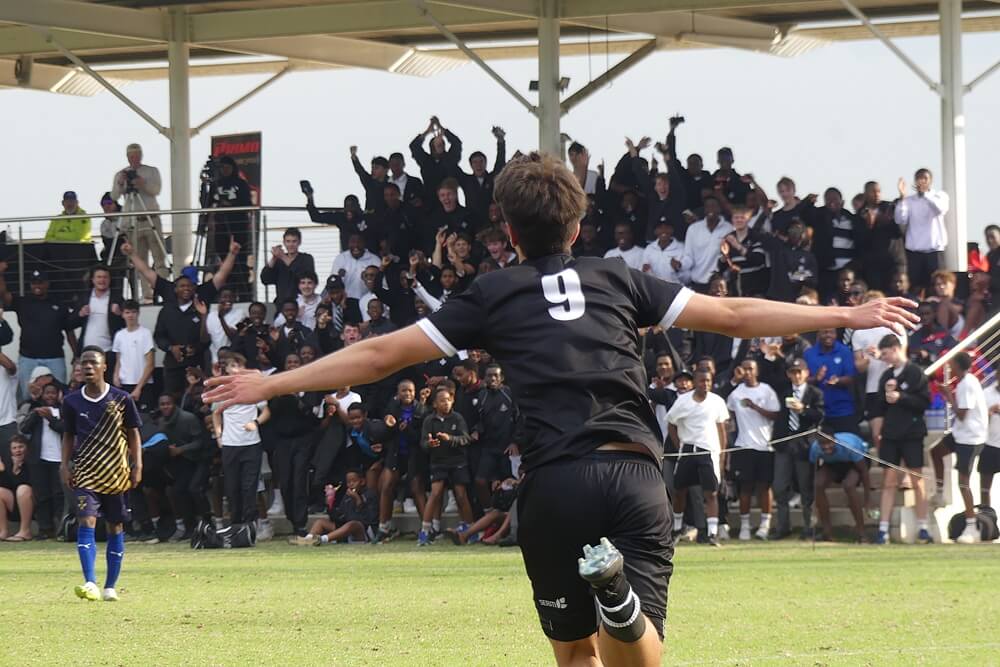 Hilton College striker Efe Ozcan races towards the crowd to celebrate scoring the opening goal in the final of the Primo Big 10. Photo: Brad Morgan.